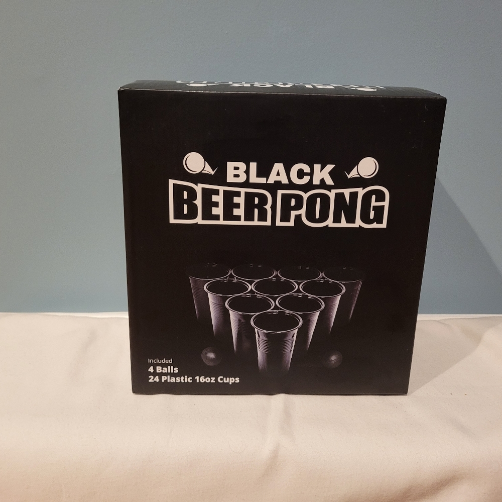 Black beer pong cups with ball.